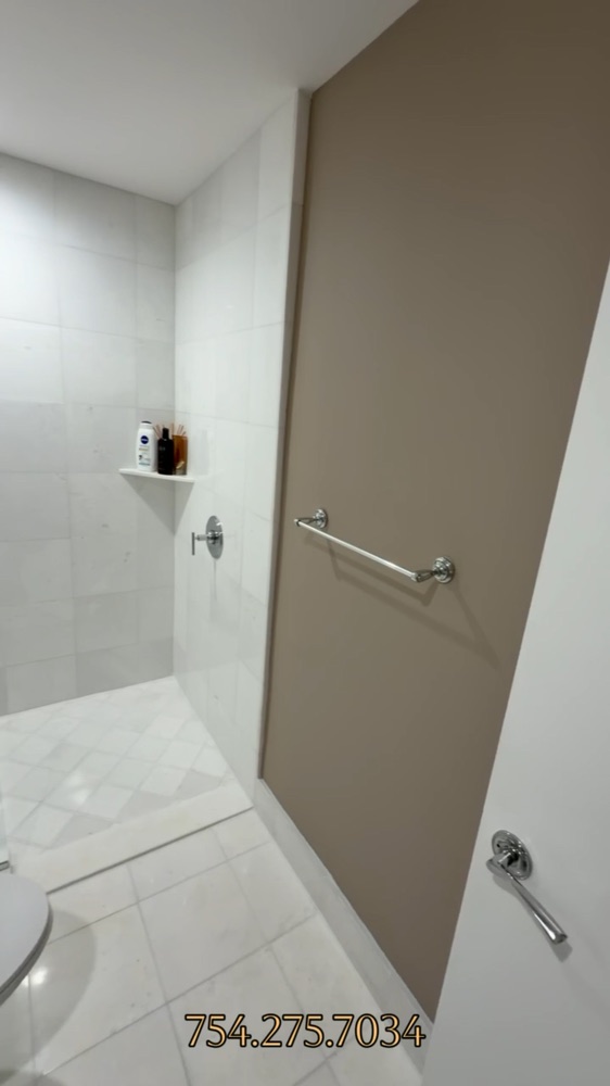 The same bathroom after the walls were repainted in a warm neutral color.