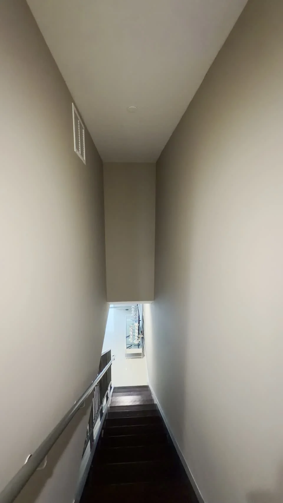 A closer look at painted stairwell walls beside a white ceiling.